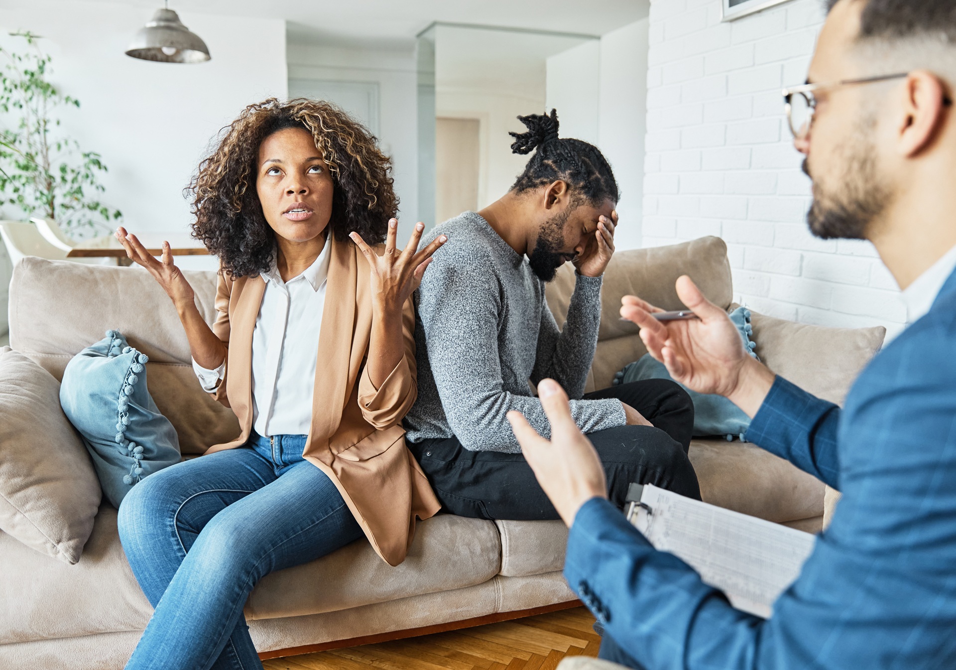 Frustrated couple talking with counsellor | Hemmat Law Group