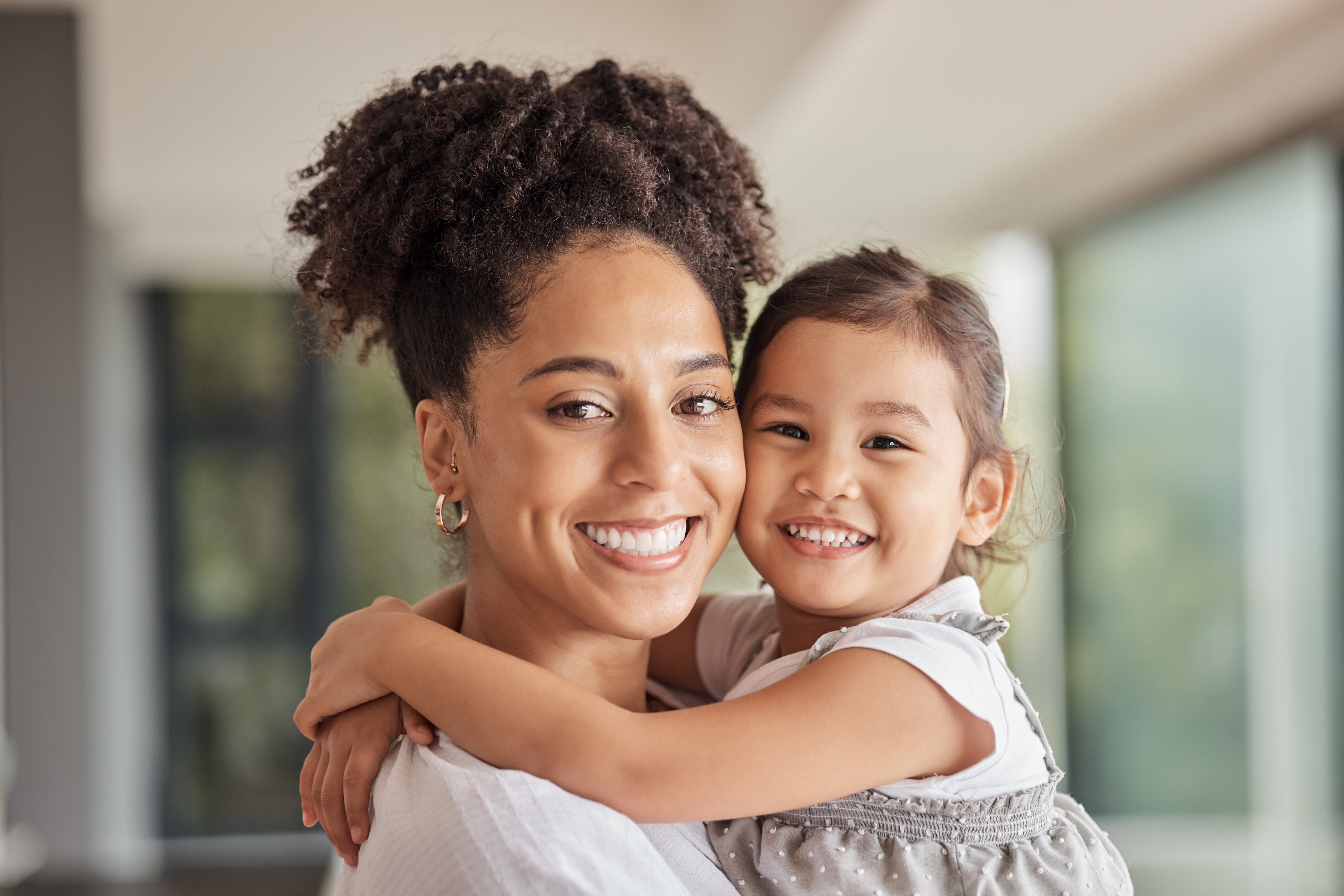 Mother and daughter smiling cheek to cheek | Hemmat Law Group