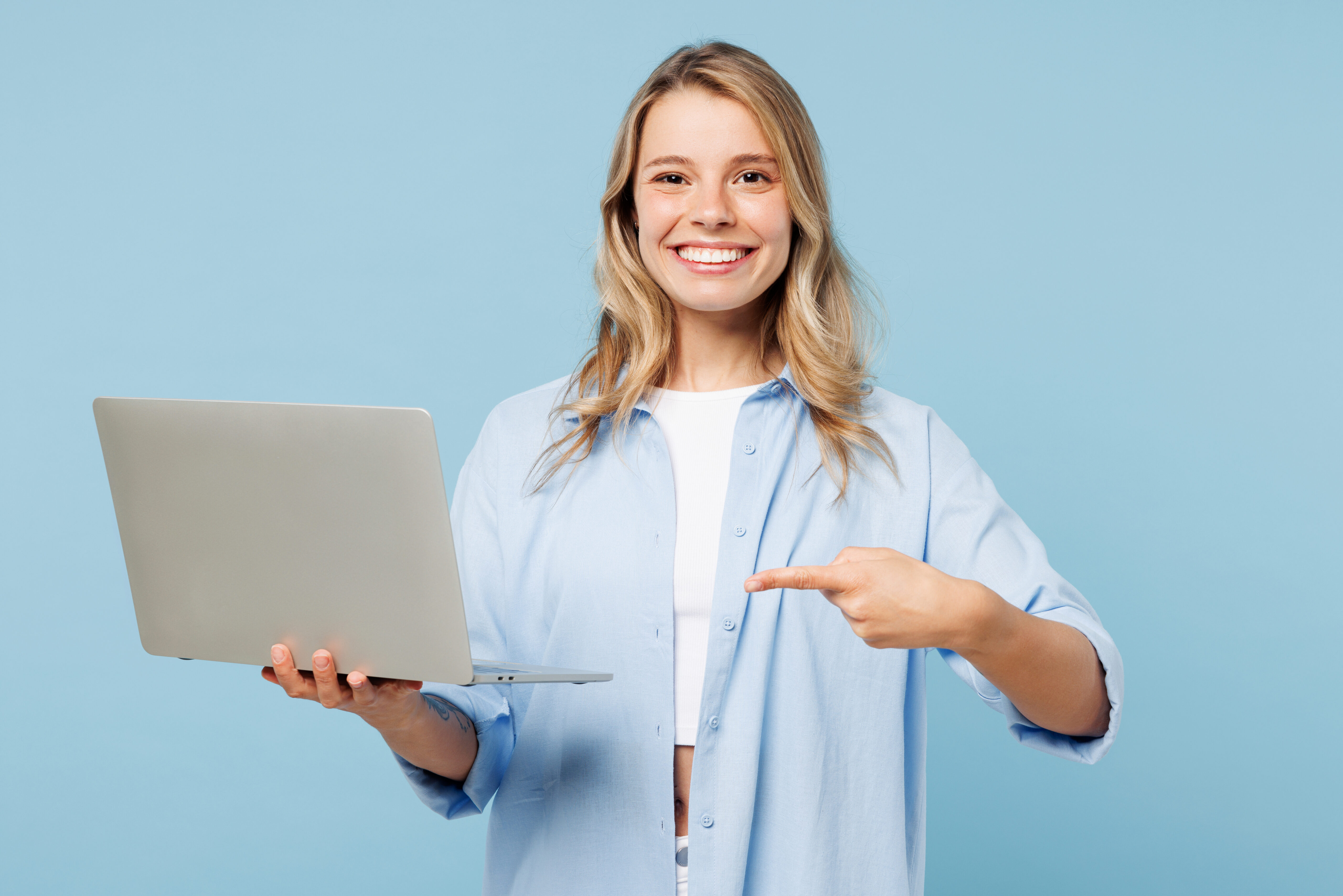 Woman pointing at laptop, smiling | Hemmat Law Group