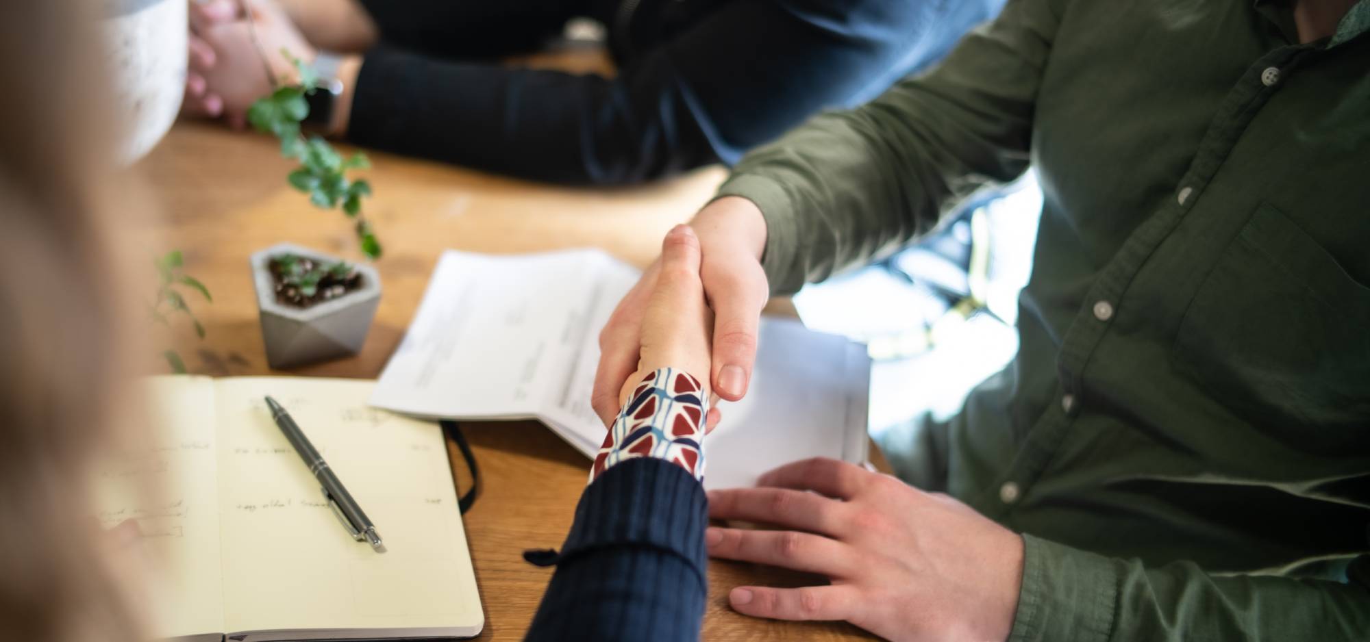 Two people shaking hands during a divorce consultation meeting | Hemmat Law Group