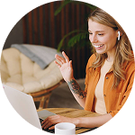 Smiling woman using laptop and waving during video call | Hemmat Law Group