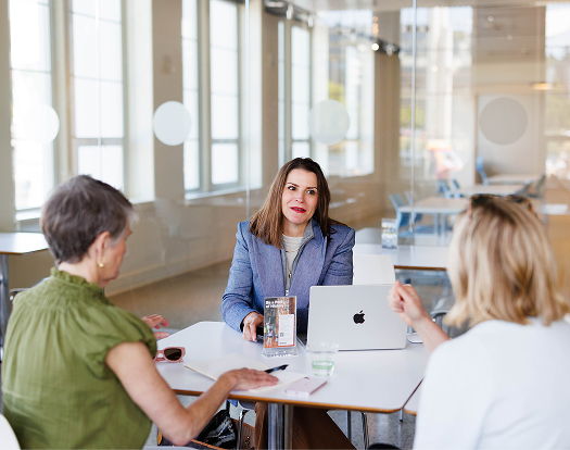 Attorney meeting with two women around an office table | Hemmat Law Group