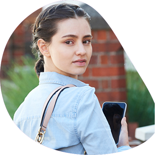 Concerned woman looking behind her while walking alone | Hemmat Law Group