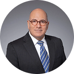 Professional portrait of a male lawyer wearing glasses and suit | Hemmat Law Group