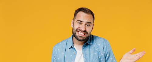 Man shrugging uncertainly, yellow background | Hemmat Law Group